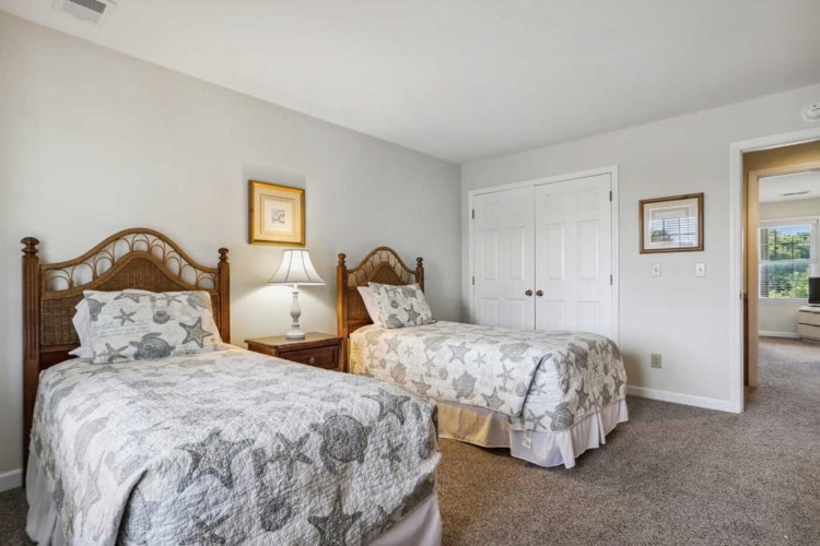 Drift off in your choice of two comfy beds, with coastal-inspired linens and charming wood headboards setting a peaceful, beach-cottage mood.