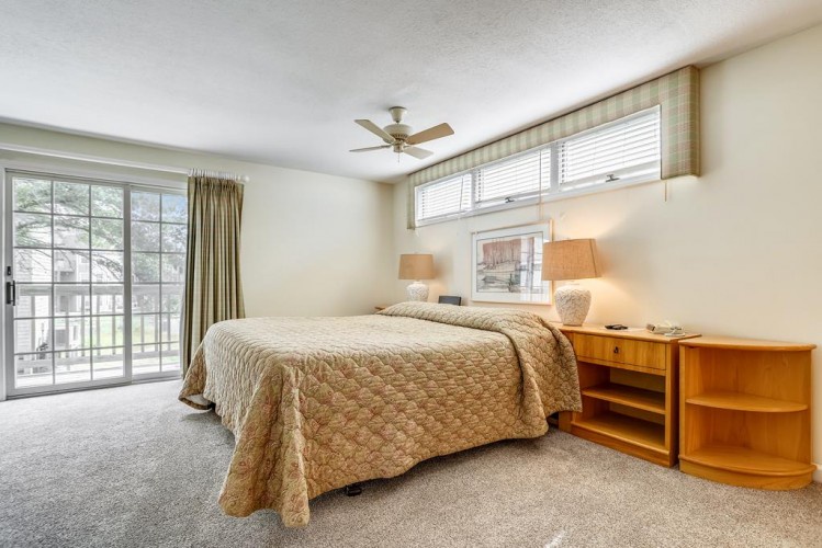 Wake up refreshed in your bright, peaceful bedroom with plush carpeting, a comfy bed dressed in soft linens, and a gentle ceiling fan overhead. Natural light and garden views invite relaxation all day.