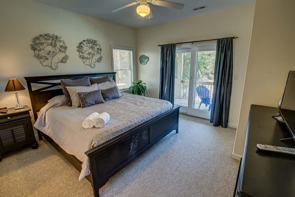Unwind in your serene bedroom where plush linens and thoughtful touches await. Step through the glass doors to your private balcony and soak in peaceful moments outdoors.
