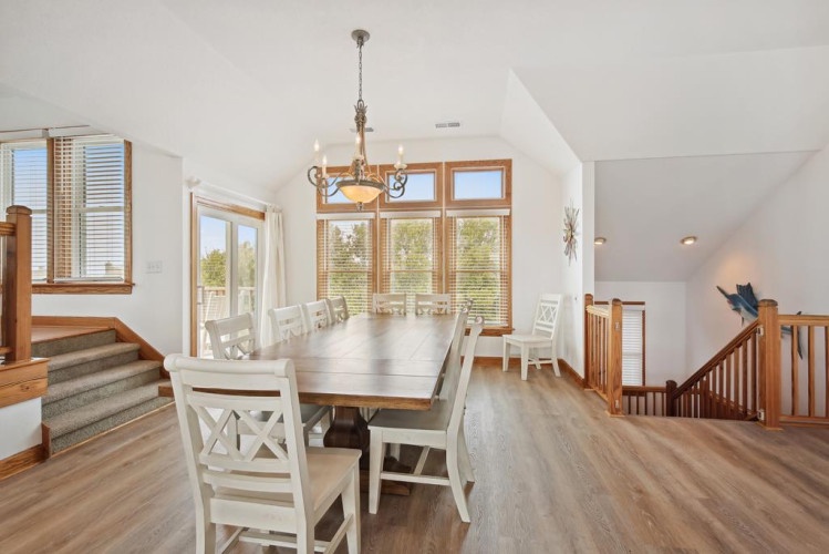 Gather around this elegant dining table with room for the whole family, flooded with natural light from large windows overlooking the surrounding landscape. Your home away from home awaits.