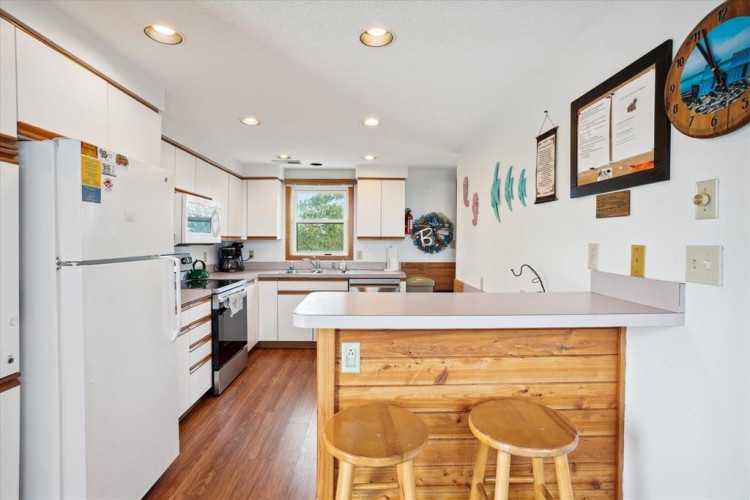 Step into your fully equipped kitchen with stainless appliances, granite countertops, and a cozy breakfast bar perfect for morning coffee or casual meals while you plan your day's adventures.