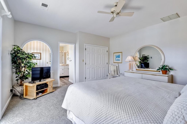 Your peaceful bedroom retreat awaits with plush linens, soft carpeting underfoot, and a ceiling fan to keep you comfortable year-round. Unwind with TV or step into your ensuite bath.