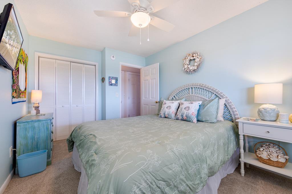 Unwind in your serene coastal bedroom, where soothing sea-foam tones and soft linens invite you to sink in and let go of the day's stress.