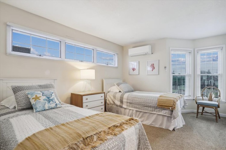 Slip into your serene twin bedroom retreat, where soft natural light pours through generous windows and coastal-inspired accents create a peaceful sanctuary for restful nights and relaxed mornings.