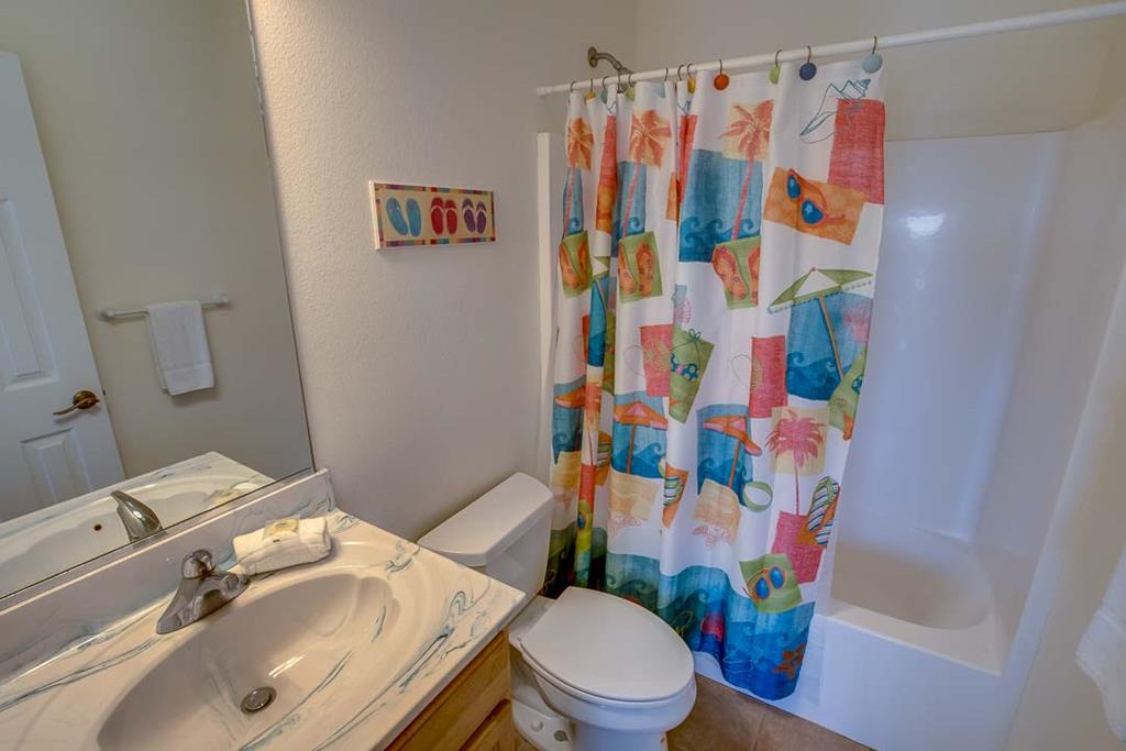Relax in your private, fully equipped bathroom with fresh towels, cheerful tropical decor, and all the essentials for a comfortable, carefree stay.