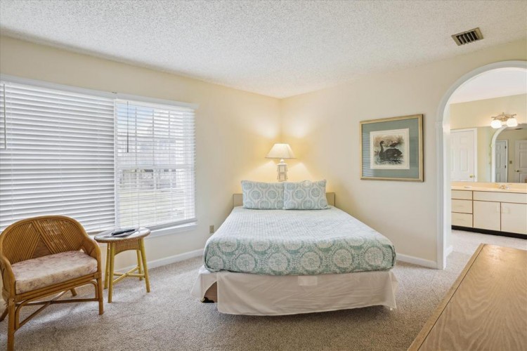 Relax in this peaceful bedroom with soft natural light, a comfy queen bed, and a private ensuite just steps away. Your perfect retreat awaits.