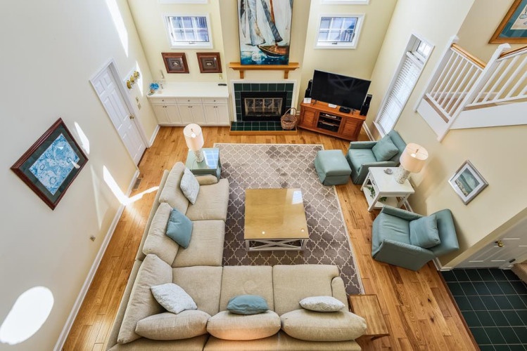 Relax in your spacious open-concept living room with soaring cathedral ceilings, cozy fireplace, and plush seating perfect for gathering with loved ones after a day of exploring.