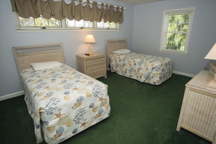 Drift off in your own twin bed in this peaceful guest room, with soft coastal bedding, gentle natural light, and plenty of space to unwind after a day of adventure.