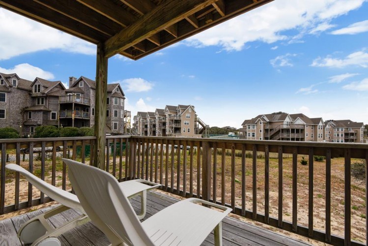 Relax on your private balcony with seating that overlooks the peaceful neighborhood and surrounding residential area.