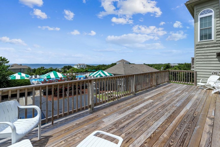 Spacious deck with coastal views and comfortable seating, perfect for morning coffee or sunset cocktails as breezes drift in from the nearby shore.