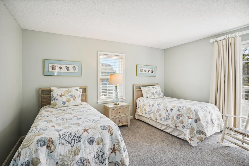 Drift off to sleep in this coastal-themed twin bedroom, where seashell bedding and soft natural light create a calm, breezy retreat for you.