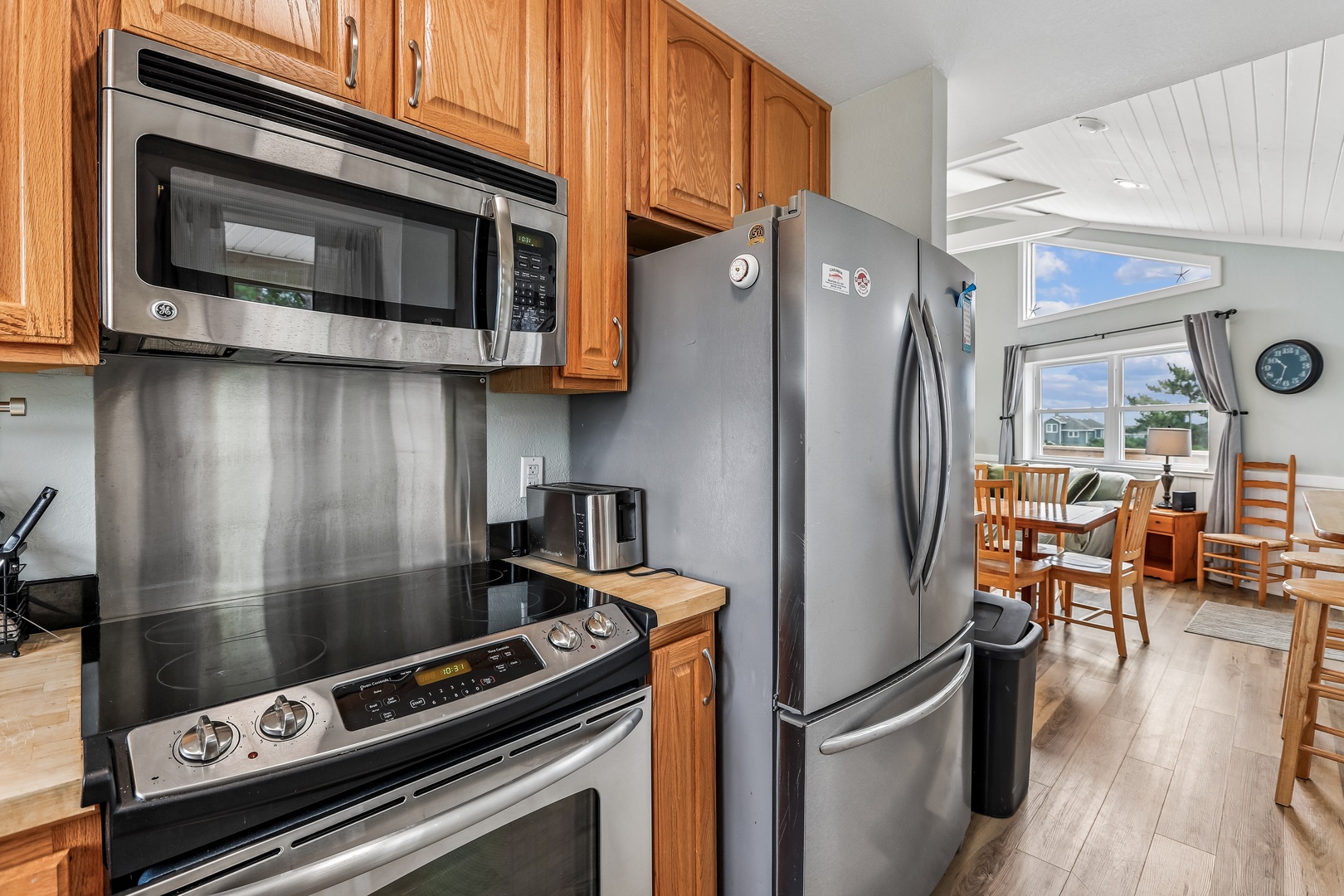 Your fully equipped kitchen makes meal prep easy with modern appliances and plenty of counter space, opening right into a cozy dining area where you can gather after a day of exploring.