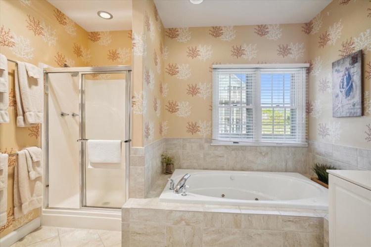 Unwind in your private spa-like bathroom, where a deep soaking tub and refreshing walk-in shower invite you to relax after a day of coastal adventures.