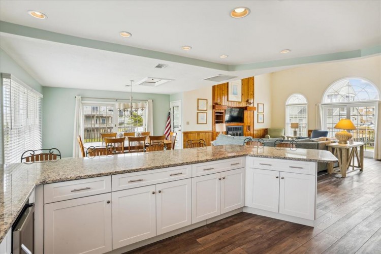 Step into this bright open-concept space where your kitchen flows into the dining and living areas—perfect for gathering, cooking, and unwinding together under the warm glow of recessed lighting.