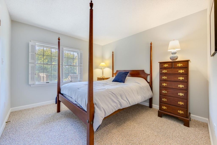 Sink into crisp linens and let your eyes rest on garden views framed by bright windows. This peaceful bedroom blends classic four-poster elegance with serene, neutral tones to help you unwind.