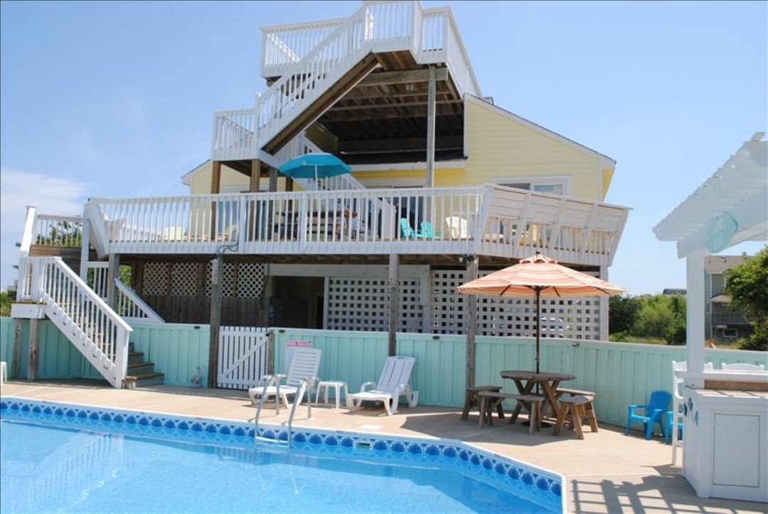 Your private pool awaits, surrounded by sundecks and shaded seating for the perfect mix of sun and relaxation. Multiple balconies offer breezy gathering spots to enjoy your coastal getaway together.