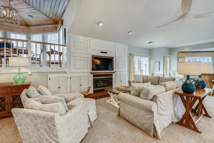 Relax in your spacious living room with vaulted ceilings, cozy fireplace, and plush seating—perfect for unwinding after a day of adventure.