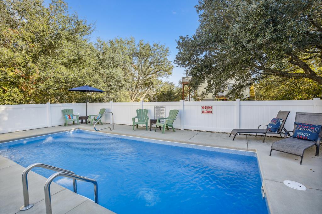 Your private pool awaits, framed by lush trees and sun loungers—perfect for sunny afternoon swims or quiet poolside moments with your favorite book.
