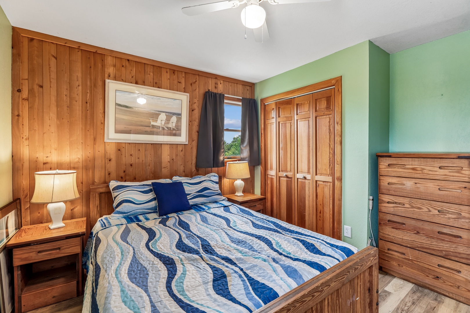 Unwind in your cozy retreat with warm wood accents and serene coastal touches. The soft ocean-inspired bedding and gentle lighting invite you to relax after a day exploring the area.