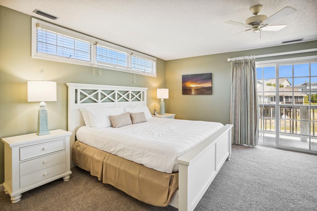 Sink into plush coastal comfort in your private bedroom, complete with soft linens, calming beach tones, and your own balcony access for morning sun.