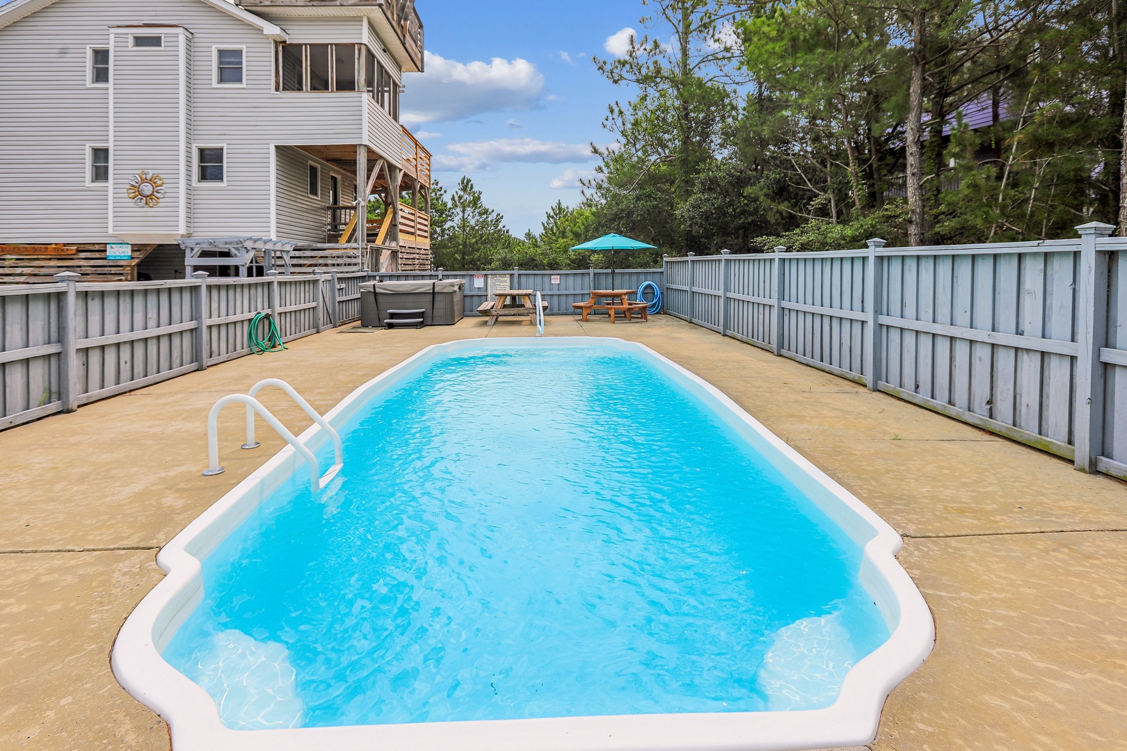 The spacious property features a private pool surrounded by a sunny deck—perfect for your morning swim or afternoon lounging under the sky.