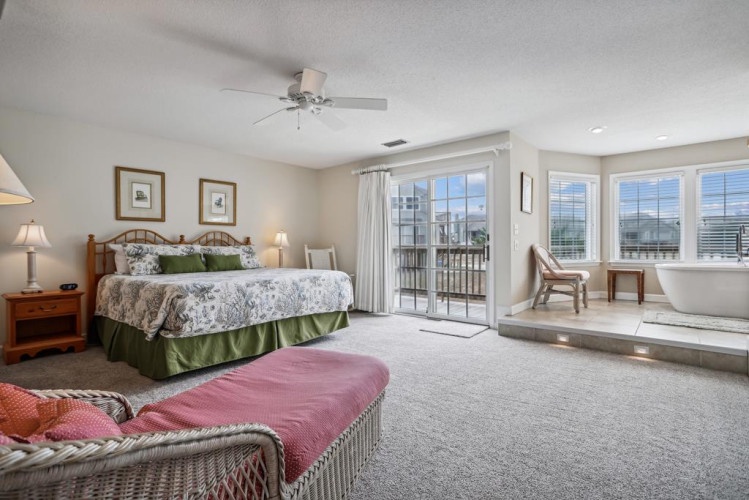Sink into a plush bed with botanical linens, bask in natural light streaming through balcony doors, and soak in your luxurious spa-style tub. Your spacious retreat awaits.