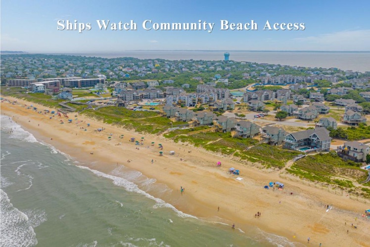 Aerial view of Ships Watch Community Beach Access showing the beachfront neighborhood and sandy shore. This coastal property enjoys proximity to the ocean and nearby community amenities.