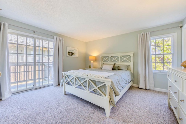 Sink into crisp linens in your peaceful retreat, where natural light pours through floor-to-ceiling windows and a private balcony invites morning coffee moments.