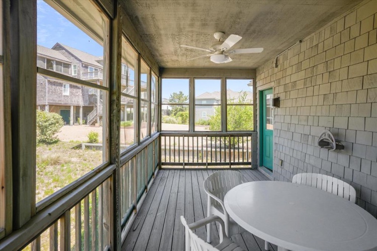Enjoy your morning coffee on this screened porch with a ceiling fan overhead, or gather around the table for sunset conversations in your peaceful coastal retreat.