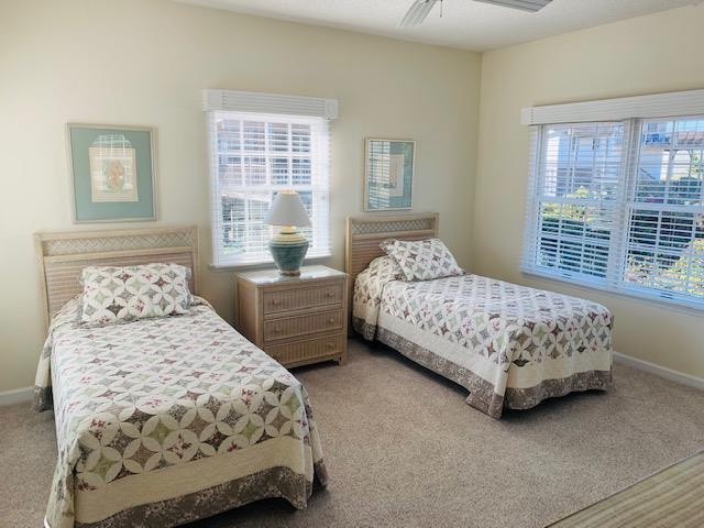 Rest easy in your coastal retreat, with twin beds dressed in cheerful quilts, natural light streaming through plantation shutters, and beach-inspired décor setting a peaceful, breezy mood.