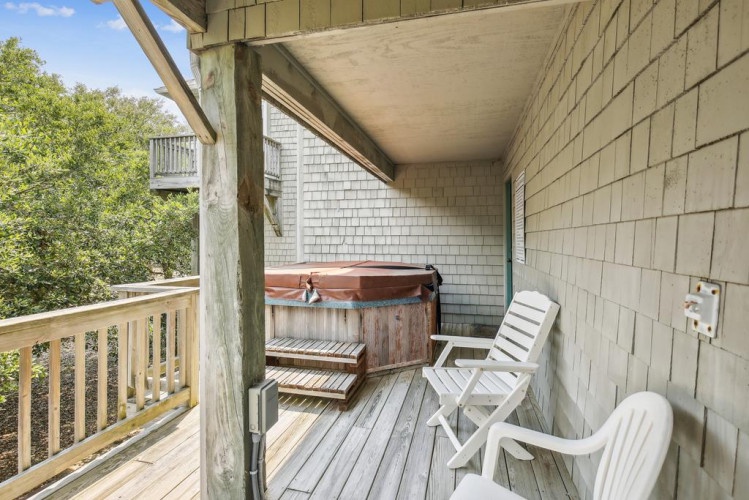 Soak in your private hot tub while surrounded by lush treetops—your perfect spot to unwind after a day of exploring.