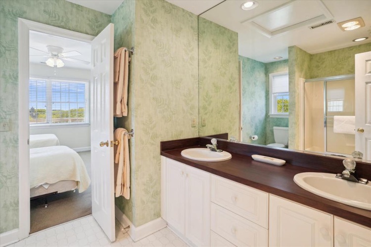 Your private ensuite awaits with dual sinks, ample counter space, and soft towels—step in from your bedroom and start each morning refreshed.