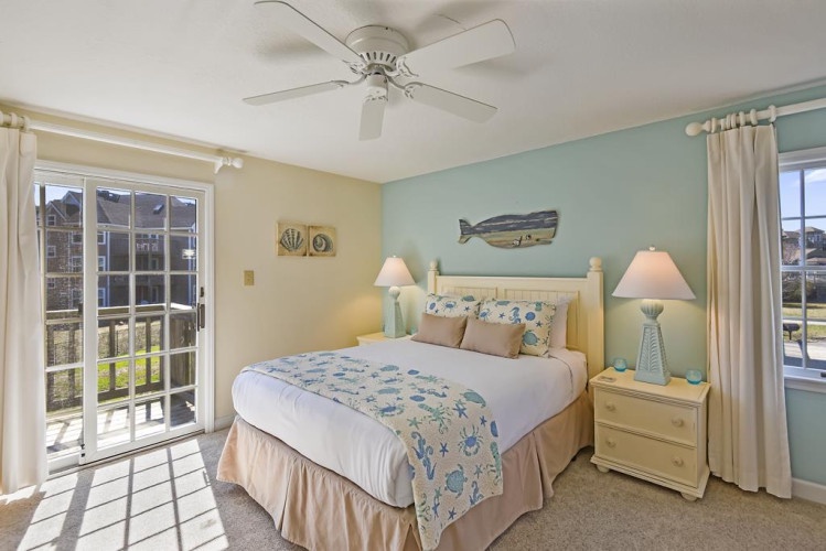 Relax in this coastal-inspired bedroom where soft beach tones and ocean accents create a serene retreat. Step out to your private balcony and let the sea breeze in.