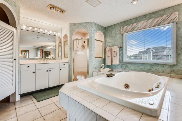 Soak your cares away in this spacious tub, enjoy the natural light pouring in, and pamper yourself in a bathroom designed for relaxation and comfort.