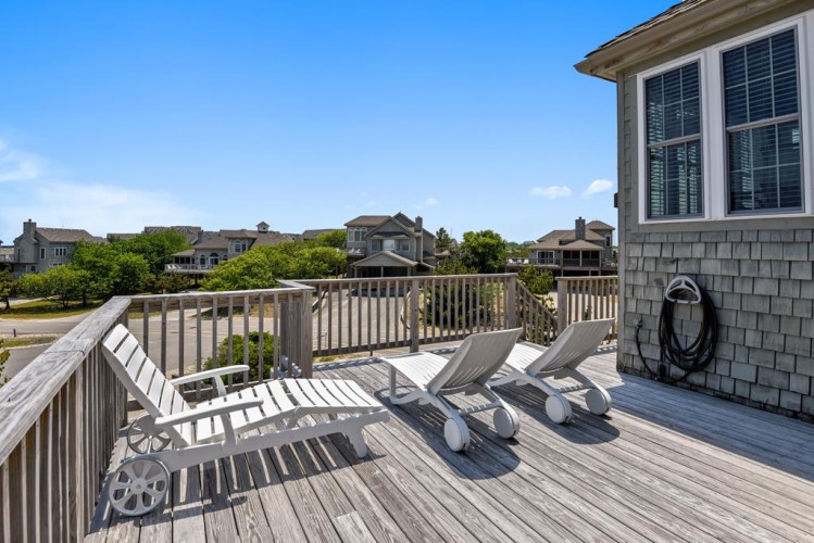Sunbathe on your private deck with lounge chairs perfectly positioned to catch the coastal breeze and warm rays—an ideal retreat after beach days.