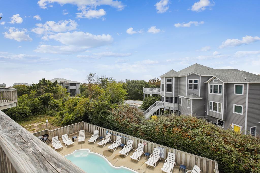Elevated coastal property featuring private pool and sundeck surrounded by lush coastal vegetation. Raised architecture maximizes ocean breezes and provides easy beach access.