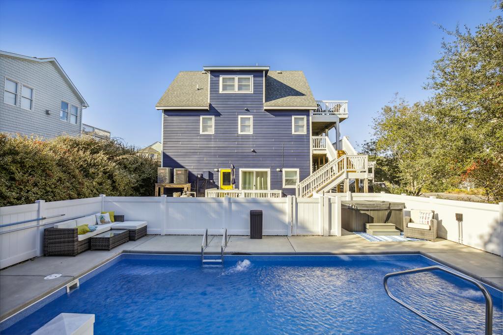 Charming coastal property with a refreshing private pool, spacious balconies, and outdoor lounge seating—perfect for sunny days and beachside relaxation.