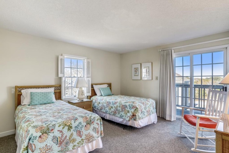 Relax in your bright, peaceful bedroom with two comfortable beds, soothing coastal décor, and a private balcony where you can enjoy fresh air and sunshine.