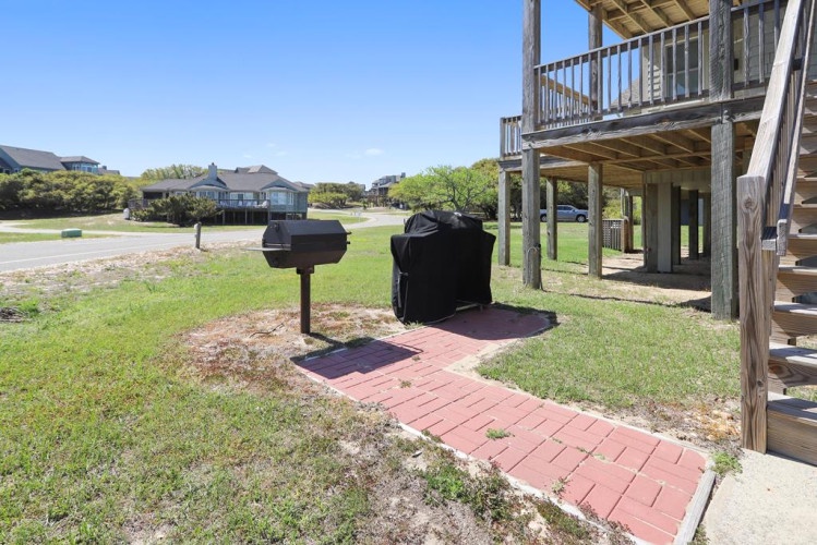 This property sits in a peaceful coastal neighborhood with a spacious yard, covered grill area, and easy access to nearby beaches and local amenities.