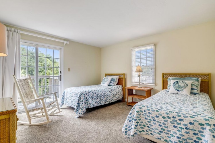 Wake up to natural light and gentle breezes from your private balcony in this serene coastal retreat with twin beds dressed in beach-inspired linens.
