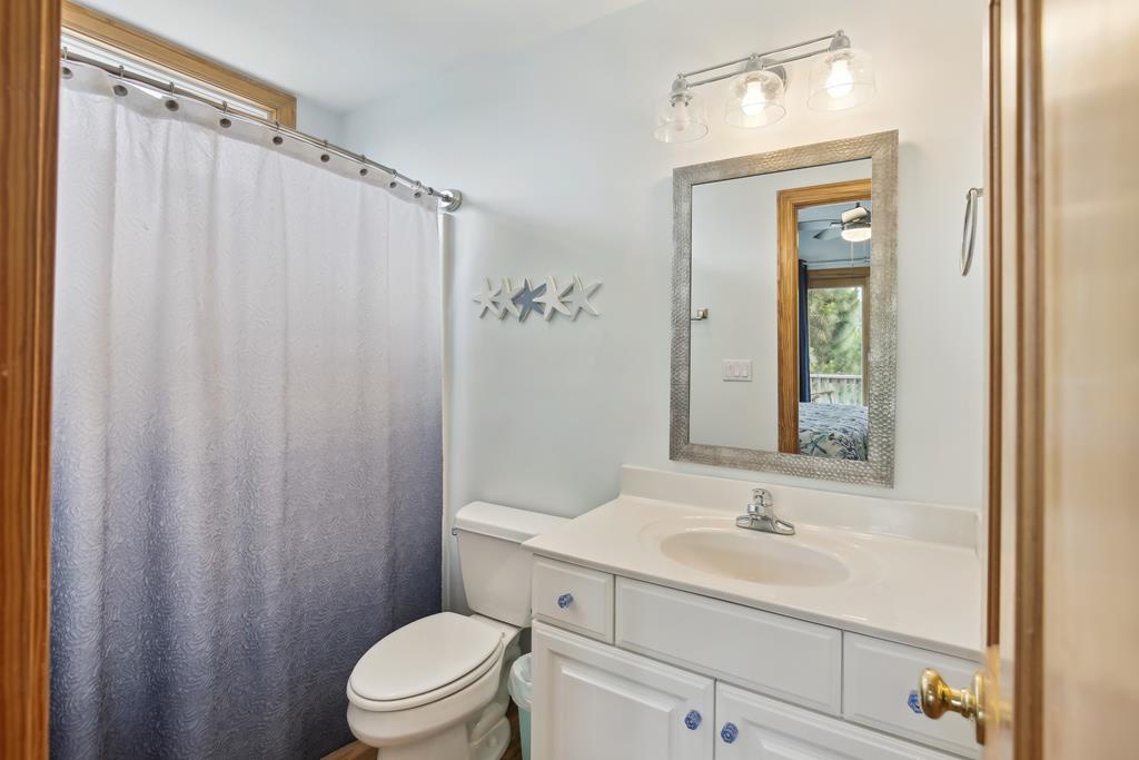 Step into this bright, spotless bathroom featuring a full tub-shower combo, sleek vanity, and modern lighting—your refreshing retreat after exploring nearby trails and attractions.