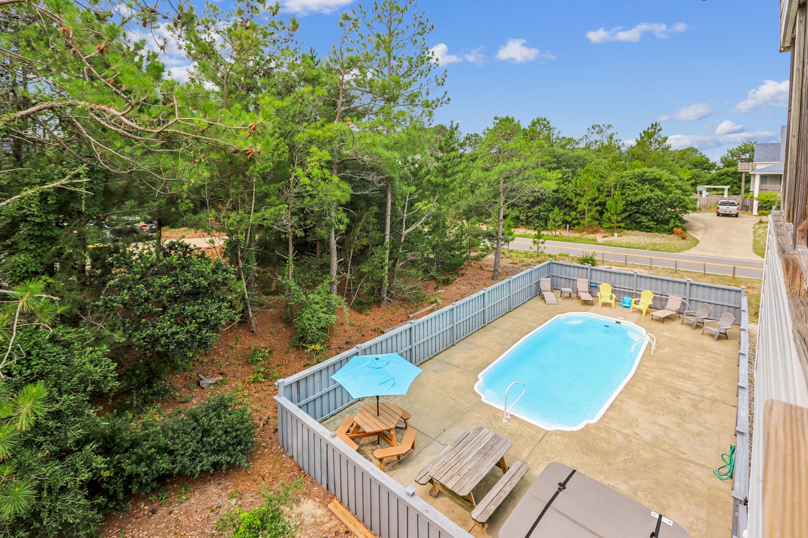 A private pool oasis awaits in your backyard, surrounded by lush pines and plenty of loungers for soaking up the sun. Perfect for refreshing dips and lazy afternoons.