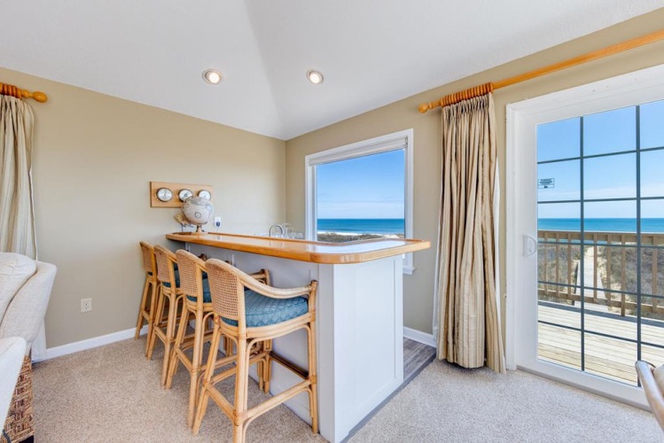 Enjoy your morning coffee at this sunny bar with sweeping ocean views from your private deck—where coastal breezes and endless blue horizons make every moment feel like a retreat.