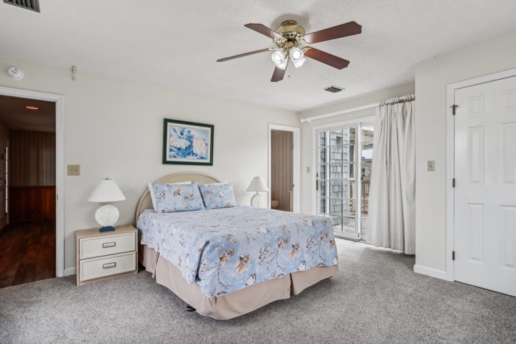 Your bright, welcoming bedroom features a comfy bed, ceiling fan, and private balcony access—perfect for unwinding after a day of adventure.