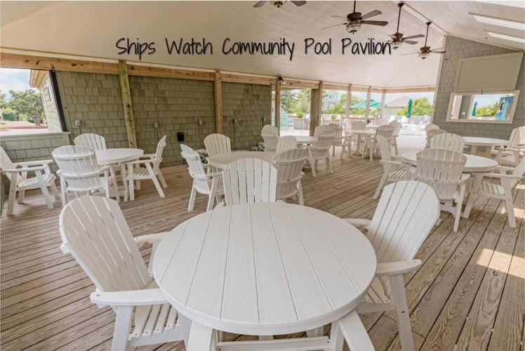 The Ships Watch Community Pool Pavilion offers a breezy, open-air gathering space with white Adirondack-style seating, perfect for relaxing after a swim or enjoying coastal views.