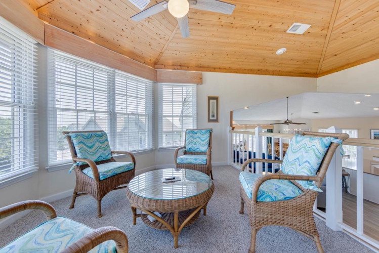 Unwind in your bright, airy sitting area with vaulted wooden ceilings and plenty of natural light. Sink into comfortable wicker seating and let coastal-inspired decor put you at ease.