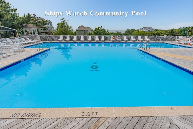 The Ships Watch Community Pool offers a sparkling outdoor oasis with ample lounge chairs and fenced deck space, perfect for your sunny vacation days.