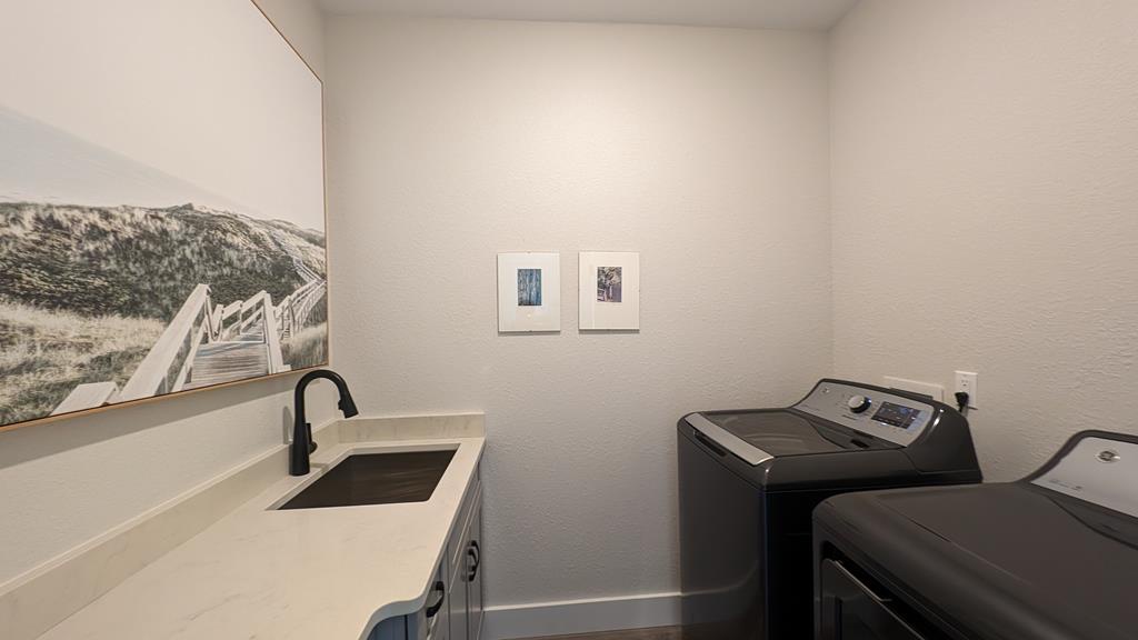 Your private laundry room features a sleek sink and full-size washer and dryer, making it effortless to refresh your wardrobe while enjoying mountain-inspired artwork.