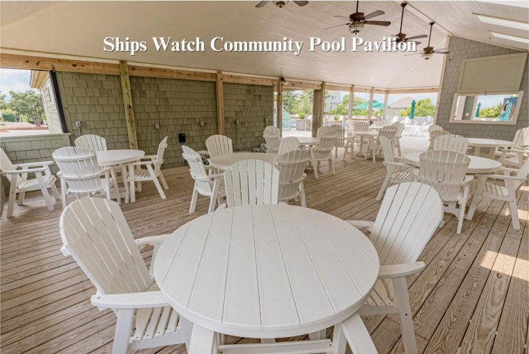 The Ships Watch Community Pool Pavilion offers a breezy covered gathering space with white tables and Adirondack chairs—perfect for relaxing after a swim or enjoying meals with family and friends.