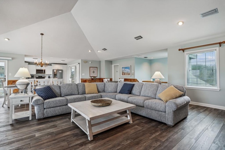 Sink into the cozy sectional and make yourself at home in this bright, airy living space, where vaulted ceilings and thoughtful design create the perfect retreat for your stay.